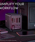 Kickstart Your Daily Hustle With This Professional Four Bay Docking Station Featuring Thunderbolt And USB C Ports For Lightning Fast Offloading Zero Lag Sync And A Rock Solid Gray Chassis That Secures Your Entire Gear Setup, view of ports and accessories on desk.