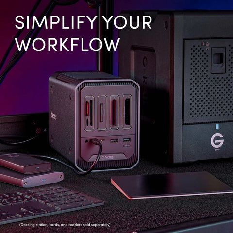 Kickstart Your Daily Hustle With This Professional Four Bay Docking Station Featuring Thunderbolt And USB C Ports For Lightning Fast Offloading Zero Lag Sync And A Rock Solid Gray Chassis That Secures Your Entire Gear Setup, view of ports and accessories on desk.