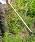 Person using Long Handle Weeding Sickle With Razor Sharp Japanese Carbon Steel Blade For Stand Up Weeding No Bending Easy Back Saving Yard Work 45 Inch Tool Made In Japan Great For Thick Weeds Gardens Lawns