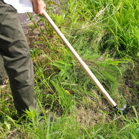 Person using Long Handle Weeding Sickle With Razor Sharp Japanese Carbon Steel Blade For Stand Up Weeding No Bending Easy Back Saving Yard Work 45 Inch Tool Made In Japan Great For Thick Weeds Gardens Lawns