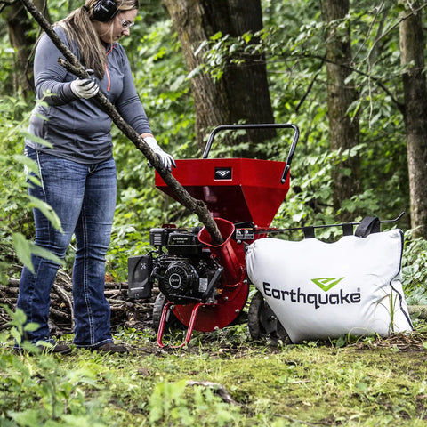 Person using Heavy Duty 301cc Chipper Shredder With 4 Cycle Viper Engine, Dock And Lock Debris Bag in forest setting
