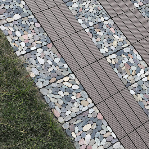 Interlocking Stone Deck Tiles 12x12 for Indoor Outdoor Use in Grey and White Real Pebble Slices installed on a grass pathway