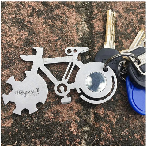 All In One Bicycle 10 In 1 Multitool Card For Everyday Carry And Keychain Access With Wrenches, Flat And Phillips Screwdrivers, Can Opener, Bottle Opener, And More, Perfect Gift For Dad And Guys, Bike Lovers, Stocking Stuffers, Under Ten Dollars shown attached to a keychain on a stone surface.