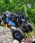 UTV with roll cage on rocky terrain showcasing Green 4 Point Harness With 2 Inch Straps For UTV Off Road Universal Fit 2 Pack Heavy Duty Safety Belt System With Quick Release Buckles Built Tough Ideal For Dirt Bikes ATVs And Trail UTVs With Weather Resistant Design Ride Ready