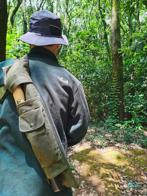 Person walking through forest wearing Axe And Saw Sling Bag For Boreal21 Folding Bow Saw Canvas Buck Saw Sheath Ideal For Agawa Saw Bag Bushcraft Camping Gear And Outdoor Adventures For Easy Carry And Quick Access