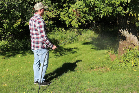 Farm Grade Adjustable Spray Gun With 50 Inch Reach, 18 Orifice, 150 Psi Max, 3 Gpm, in use by man watering plants