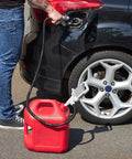 One Hand Electric Fuel Transfer Pump With Flow Control Nozzle And D Battery Power Hands Free Gas Can Pump For Liquids And Water Jugs 2 Point 4 GPM Flow Long Suction Tube For Tall Containers used with a red gas can at a car fuel tank