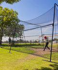 40 Foot Collapsible Batting Cage For Backyard Or Indoor Baseball And Softball Practice With A Heavy Duty Rust Resistant Steel Frame And UV Protected Net Black Frame Easy Setup Durable Year Round Hittin Cage in use