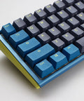 Kickass Sixty Percent Compact Mechanical Keyboard With Hot Swappable Top Tier Keys And Double Shot PBT Keycaps Dual Layer Sound Dampened Construction Plus Custom RGB Lighting For Daily Typing And Gaming Vibes That Totally Slam, angled view showing blue and gray keycaps.