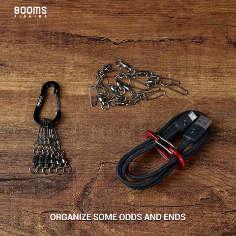 Two Inch Aluminum D Ring Carabiner Clips Pack Of Six Assorted Colors for organizing cables and keychains on wooden surface.
