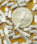 Barrel Screw Type Clasp Set 100 Pieces 4 x 15 mm Durable Silver Tone Jewelry Clasps next to a quarter for scale
