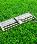 Stainless Steel 30 Inch Lawn Level Rake Pro Grade Yard Tool for even grass and smooth soil leveling with long handle in use on grass