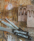 Pro Grade Heavy Duty Eight Inch Half Round Hand Rasp With Slick Ergonomic Soft Grip Handle and tough tungsten carbide coating on workbench.