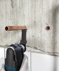 5 Piece Starlock Oscillating Multi Tool Blade Set cutting metal pipe in wall, showcasing plunge blade use for metal.