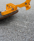 Kickass Three Magnet Manhole Lid Lifter Pulls Up To Two Hundred Fifty Pounds No Sweat, lifting a manhole cover with yellow handle.