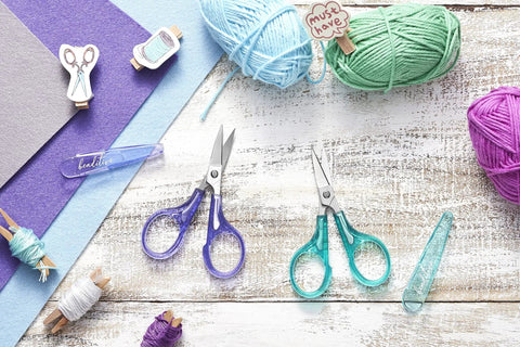 Curved And Straight Craft Scissors Set For Embroidery And Sewing, Multipurpose Stainless Steel With Protective Covers, Green And Purple Handles, Ideal For Paper Cutting, Detailing, And DIY Craft Projects, shown with yarn and felt