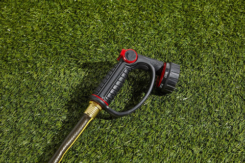 Side view of 7 Pattern Watering Nozzle With Thumb Control For Backyard Bosses From Rainlike Shower To Powerful Jet on grass