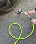 Using Heavy Duty Hybrid Air Hose 3/8 X 10 Ft to inflate a tire, showing kink-free flexibility and industrial fittings.