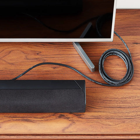 Toslink Digital Optical Audio Cable With Gold Plated Connectors For Soundbars And Home Theater, 9.8 Feet, connected to a soundbar.