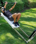 Person using EZ Curl Bar for heavy weight training on Bowflex and home gym cable systems with neutral grip outdoors