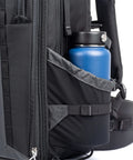Side view of 46L Camera Backpack For Travel Photography With Expandable Front Pocket holding a blue bottle