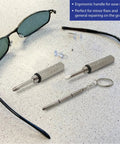 Tiny Precision Screwdriver Set For Eyeglasses, Watches, Phones And Jewelry with flat and Phillips bits, shown with sunglasses on a table.