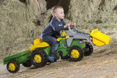 Child riding a green Pedal Tractor With Working Front Loader And Detachable Trailer For Kids Ages 3 And Up, outdoors in hay