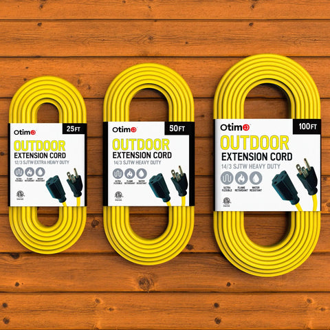 Three yellow outdoor extension cords, 25ft, 50ft, and Heavy Duty 100 Foot 14 3 SJTW with 3 prong ground plug, on wooden surface.