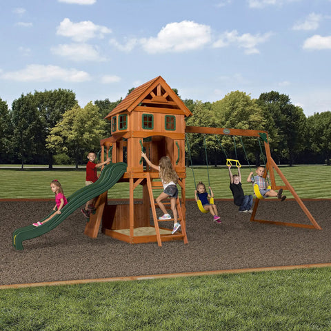 Children playing on Atlantis Cedar Wood Swing Set With Wave Slide And Raised Clubhouse Featuring Rock Wall, Belt Swings.