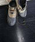 Tough As Nails Vinyl V Groove Floor Mats For Garages Shops And Commercial Spots Oil Grease Chemical Resistant Non Slip Anti Fatigue Mat In Black One Eight By Twenty Four By Sixty Inches with muddy shoes on the mat.
