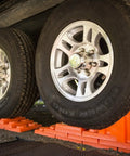 Stop N Chock 2 Pack For No Fuss Safe Parking And Easy Stabilization interlocking orange PLA chocks under RV tires