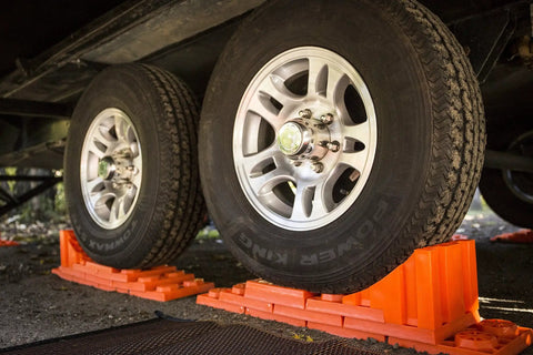 Stop N Chock 2 Pack For No Fuss Safe Parking And Easy Stabilization interlocking orange PLA chocks under RV tires