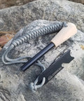 Ferro Rod Fire Starter Kit With A Large One Half Inch Rod, Fire Tinder And Custom Carry Pouch, All In One Survival Fire Starting Tool Package For Backcountry Camps And Emergencies In Green displayed on a rock