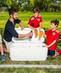Group enjoying drinks from Beast Mode Heavy Duty 120 Qt Polar Cooler with UV Shield Lid in a park setting