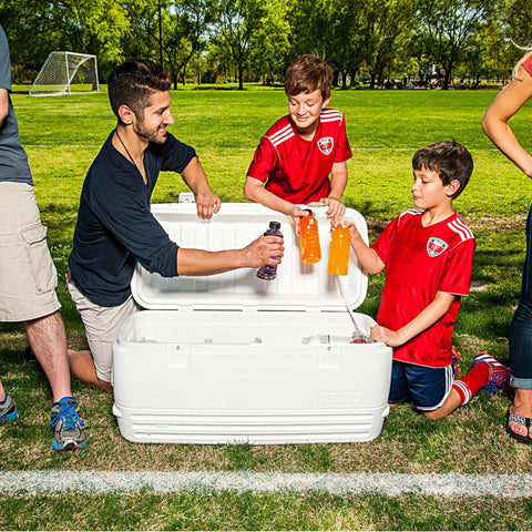 Group enjoying drinks from Beast Mode Heavy Duty 120 Qt Polar Cooler with UV Shield Lid in a park setting