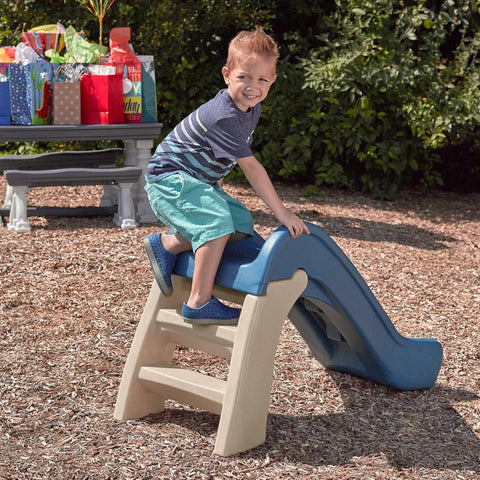 Toddler playing on Play And Fold Junior Slide For Toddlers 1.5 To 4 Years Old Indoor Outdoor Backyard Playground Set With Easy Grip
