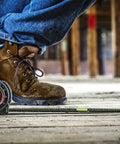 Worker using 1-3/16 Inch By 25 Foot Dual Sided Tape Measure With Nite Eye Glow, Shockforce Blade And Matte Black Nylon Coated Blade