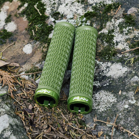 Holeshot Lock On Mountain Bike Grips With 22mm Inner Diameter in Olive Green on mossy rock background