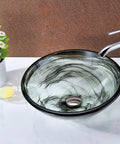 Mezzo Slumber Wisp Sleek Tempered Glass Vessel Sink Bowl In Grey Finish, modern round vessel with pop up drain on marble counter.