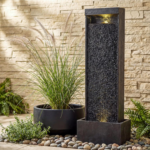 35 Inch Outdoor Water Fountain With Modern Curved Faux Slate Resin Waterfall And 2 Warm LED Lights For Garden Patio Yard Deck Porch Balcony Decor Home Art Water Feature In Black Keeps Your Outdoor Vibe On Point next to potted plant on stone path