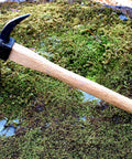 Beast Of A Heavy Duty Japanese Hand Forged Steel Pick Axe For Digging And Weeding Gardens 14-3/4 Inch Mattock Tool on moss