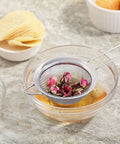 Ultra Fine Mesh Strainer With Handle Stainless Steel Kitchen Sieve 3.35 Inch Small Filter in action with rose petals in a glass bowl
