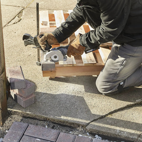 Using the Rock Solid Heavy Lifter 20V Compact Circular Saw Kit for precise wood cutting with a depth guide on a worksite.