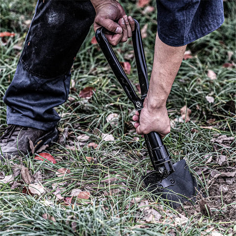 Person using Folding Camping Shovel 22.8 Inches Offroad Ready Survival Shovel Crafted From High Carbon Steel Black Lightweight EDC