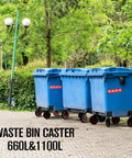 Blue waste bins with wheels outdoors on pavement next to green trees and lanterns.