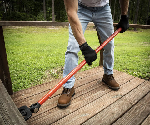 Person using Beast Mode 44 Inch Indexing Deck Removal Bull Bar With Double Fork Design on wooden deck