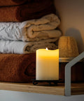 Six Count Real White Wax Flameless LED Pillar Candles 3 By 4 Inches With Remote And Timer Dimmable Flicker Battery Powered on shelf