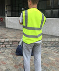 Person wearing Must Have High Visibility Reflective Safety Vest 10 Pack Neon Yellow Gear For Outdoor Work And Play