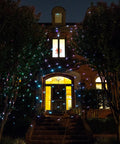 Motion Snow Fall Light Show With White Laser And 7 Color Star Effects Christmas Lights on house exterior at night