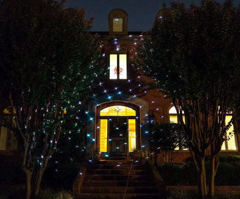 Motion Snow Fall Light Show With White Laser And 7 Color Star Effects Christmas Lights on house exterior at night